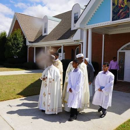 Clergy and altar servers outside the church